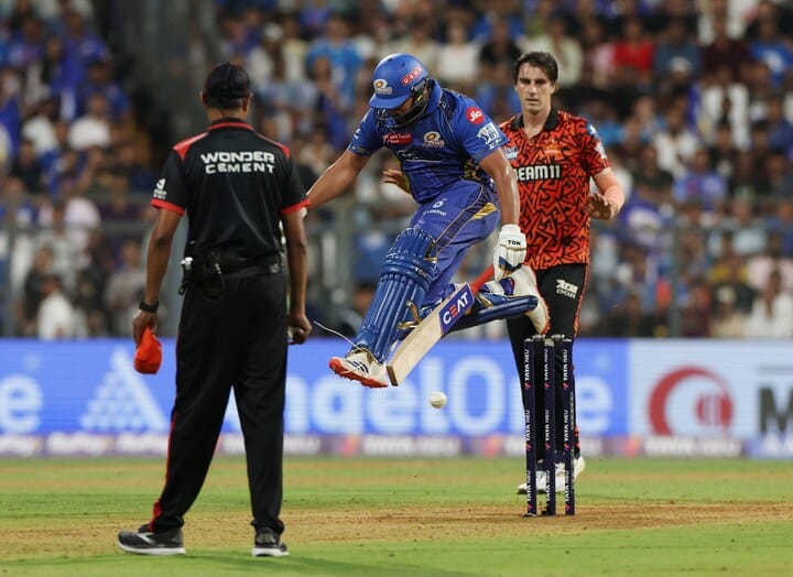 a man jumping in the air with a bat